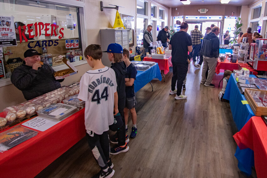 Visitors walk through the Tower Avenue Mall in Centralia on Saturday, March 9, to see what vendors were selling during the Keiper's Cards and Memoriabilia Show.