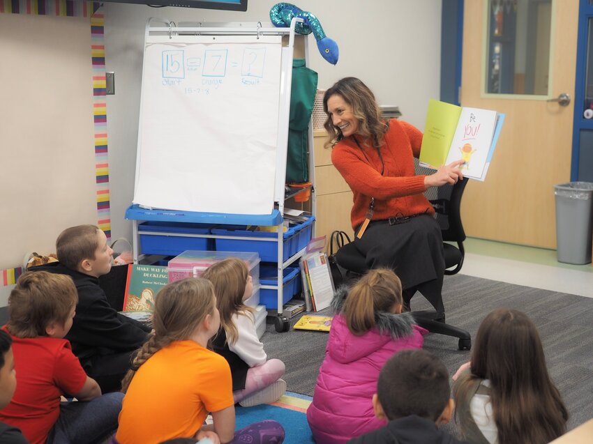 Centralia Schools Superintendent Lisa Grant reads with students in this photo provided by the chamber of commerce.