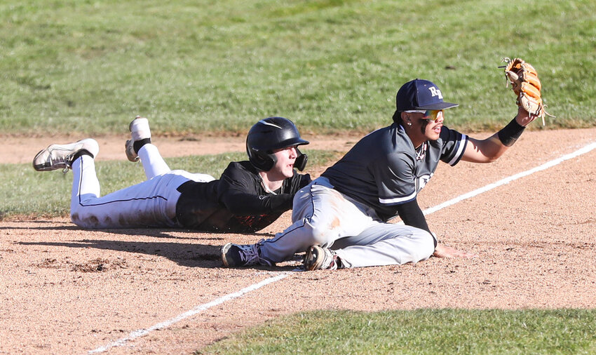 Centralia's Brady Sprague (left) is called safe after stealing third base against River Ridge on March 15 at Wheeler Field.