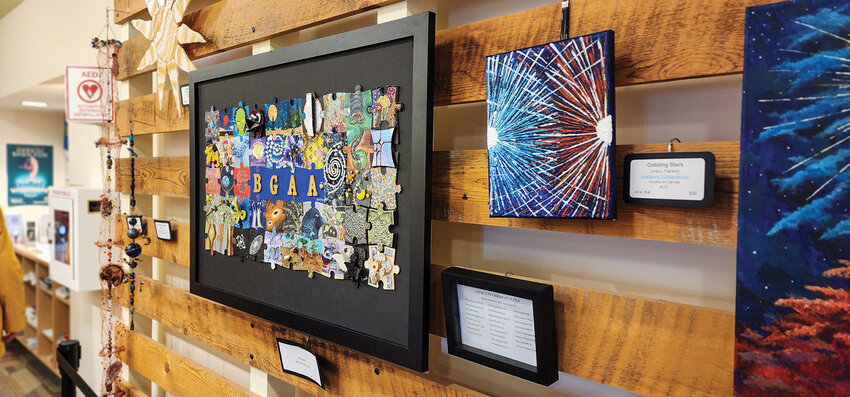 The Battle Ground Art Alliance puzzle hangs proudly at the exhibit entrance, with each created collaboratively between multiple group members and organized by artist Connie Ford.