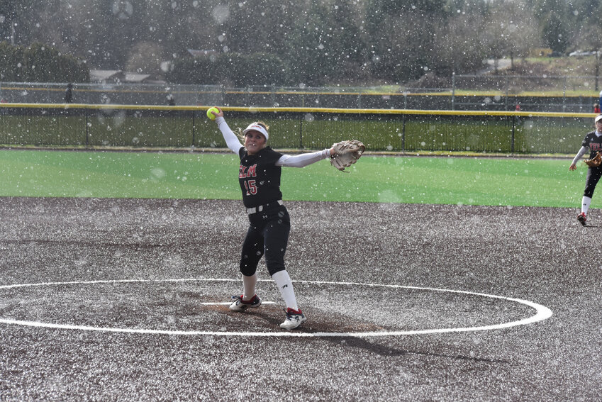 Sophomore pitcher Mallory Hoke delivers a pitch against Olympia on Tuesday, March 12, in the middle of a hail storm.