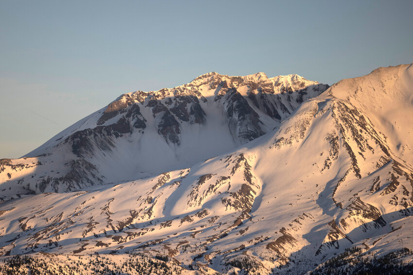The sun sets on Mount St. Helens on Saturday, March 16. Spending packages recently passed in Congress include $180,000 for the Army Corps of Engineers to monitor sediment at Mount St. Helens.