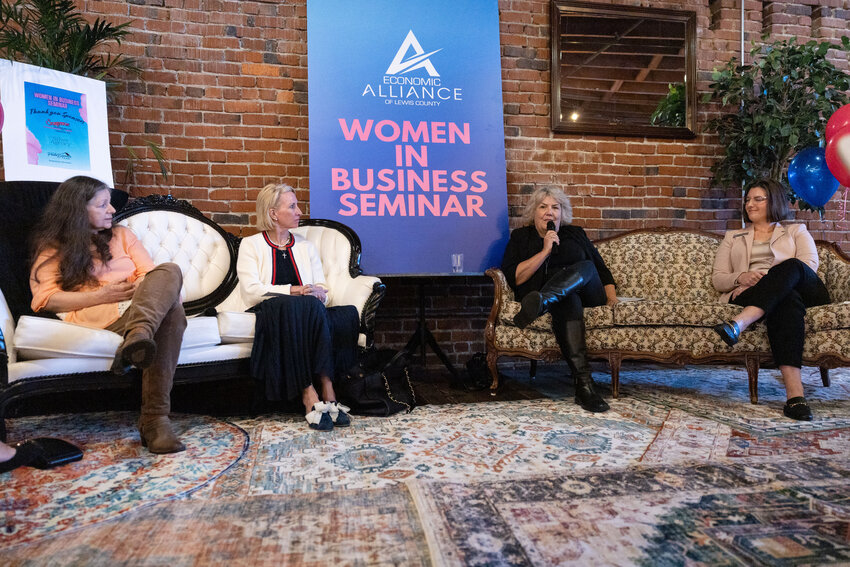 Lisa Perry, with Sierra Pacific, speaks into the microphone during the Women in Business Seminar at the Loft in Chehalis on Tuesday, March 19. With her on stage, from left, are fellow panel members Joy Templeton of Once Upon a Thyme, Hedi Pehl of I-5 Cars and Mary Ferris of Rainier Eye.