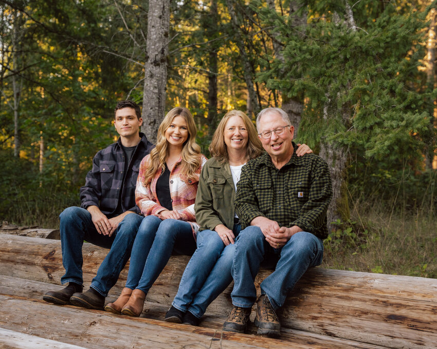 From left, Eric Girton, Emily Girton, Sharon Madsen and Sam Madsen smile for a photo at Coal Creek Tree Farm in Chehalis.