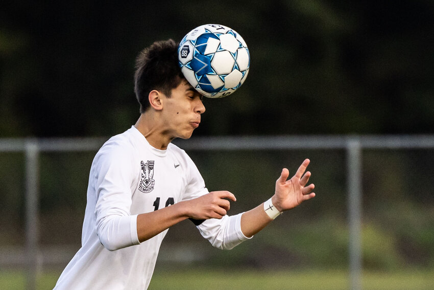 Tumwater's Malachi Vuong (16) attempts a header during a soccer game at Rochester High School on Tuesday, March 26.