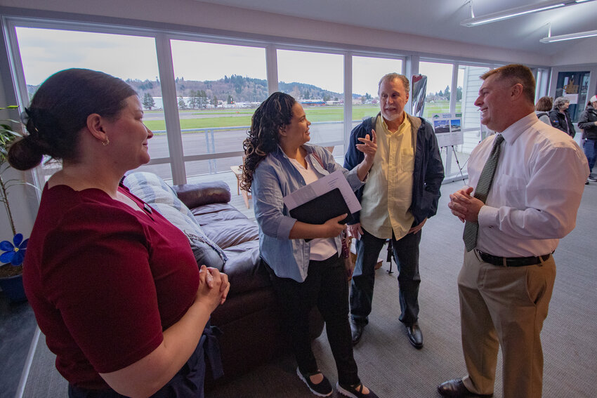 Starting on the left, Aviation Planning Group Project Manager Leah Whitfield, Tanisha Harris, Southwest Washington outreach director for U.S. Sen. Maria Cantwell, Chehalis Mayor Tony Ketchum and Chehalis-Centralia Airport Director Brandon Rakes talk about proposed upgrades to the airport at a master plan update open house on Wednesday, March 20.