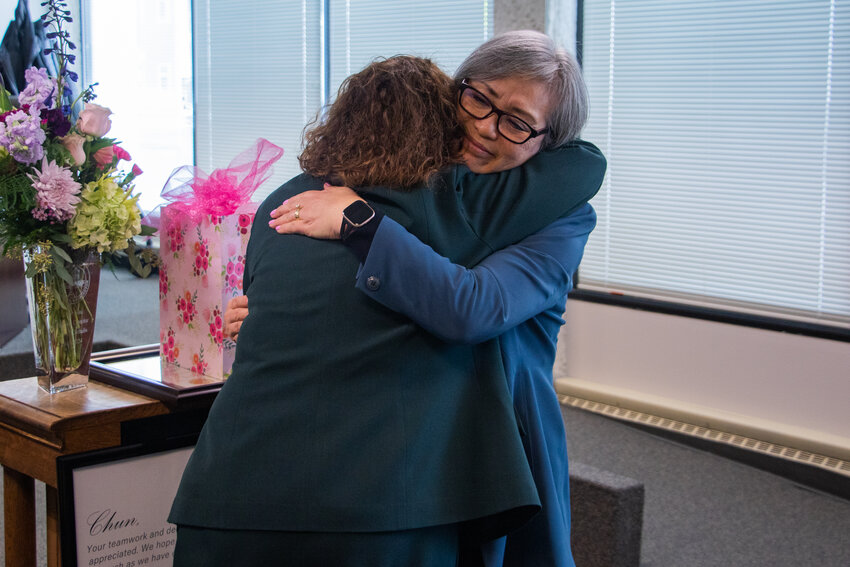 Chehalis City Manager Jill Anderson, left, hugs retiring Chehalis Finance Director Chun Saul on Monday, March 25, during a city council meeting at Chehalis City Hall.
