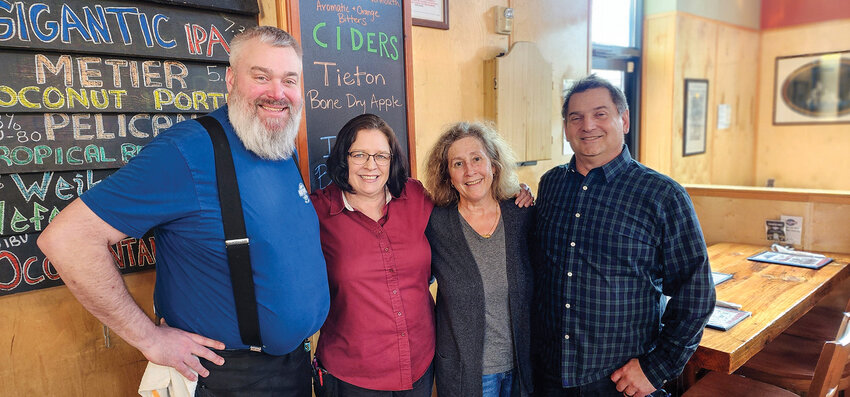 From left to right, Jarod Kay and Fran Schreiber pose at Northwood Public House with owners Paula and Eric Starr. Kay and Schrebier have worked there since its opening in 2014.