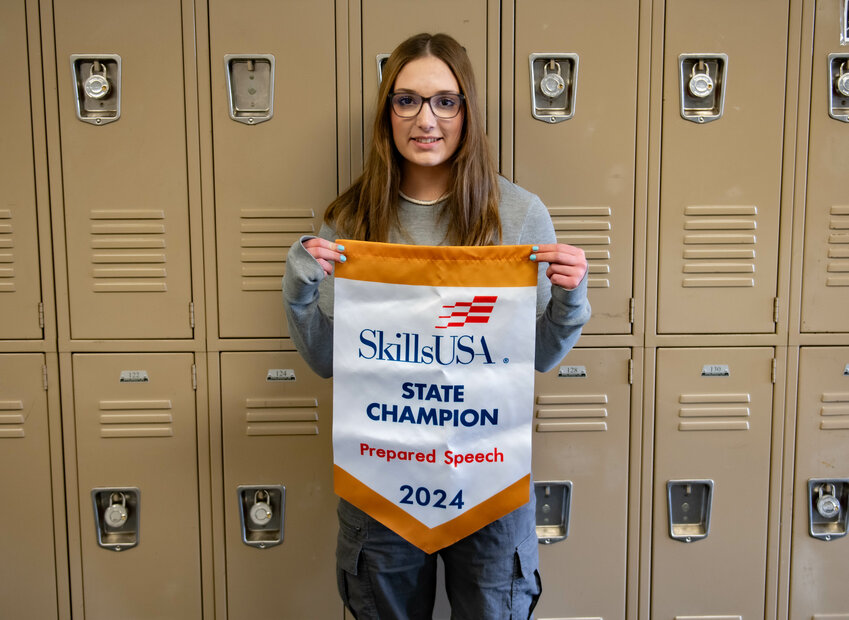 Lyla Kirkpatrick smiles with her SkillsUSA State Champion banner on Friday March 29. at Napavine High School.
