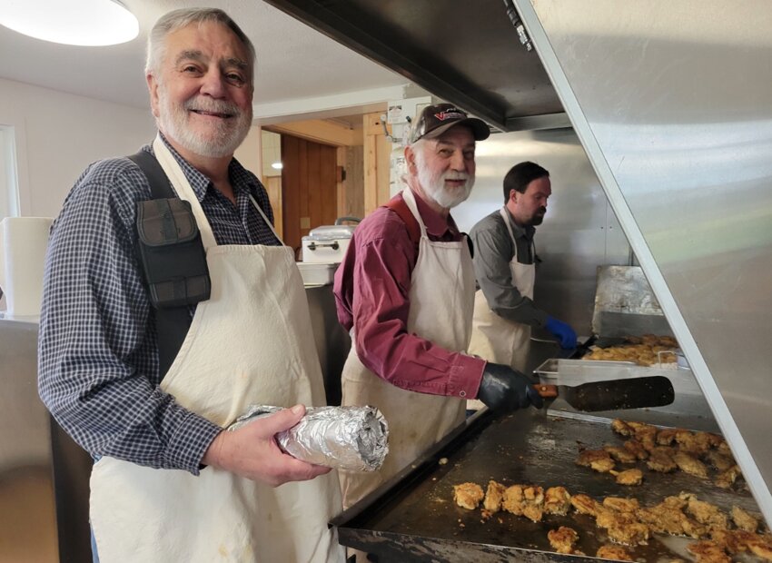 From the left, brothers Karl and Gene Goeres cook fried oysters alongside Karl's son Bret during an oyster feed at the Sharon Grange in this photo courtesy of Sharon Grange President Debbie Hill.
