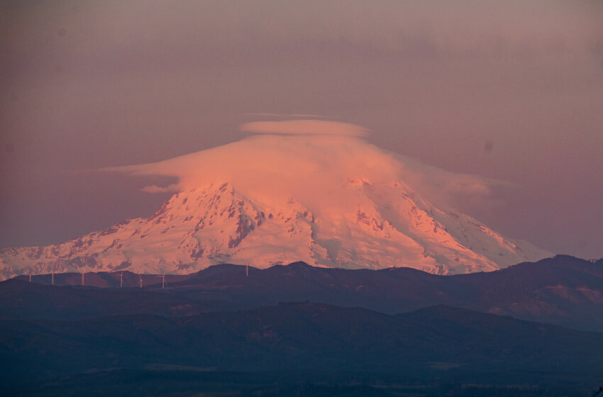 Lenticular &ldquo;cap&rdquo; clouds appear above Mount Rainier at sunset on Easter Sunday, March 31, photographed from Crego Hill Road in Adna.