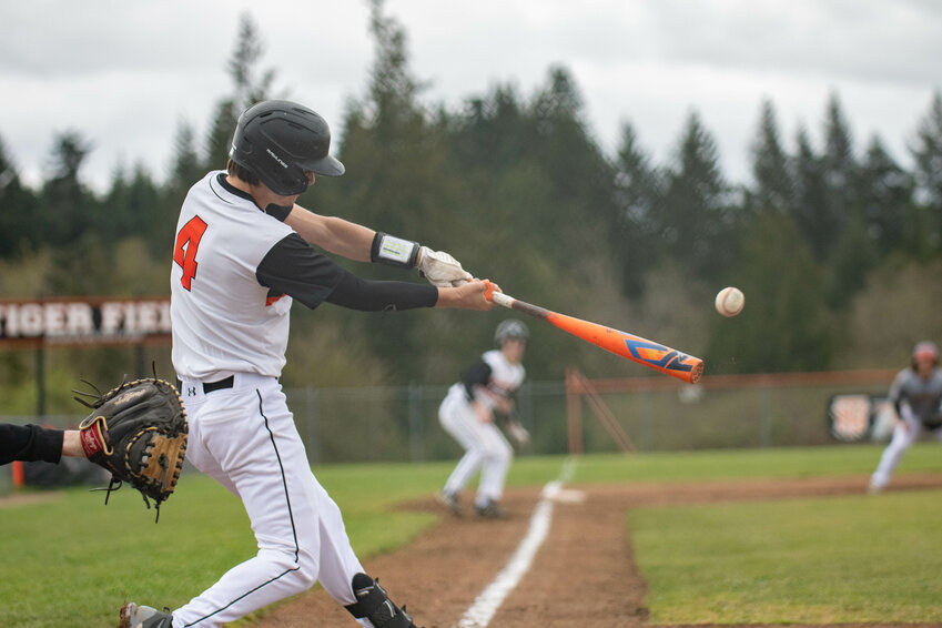 Ashton Demarest hits a fly ball during Napavine&rsquo;s win over MWP at Napavine High School on April 8.