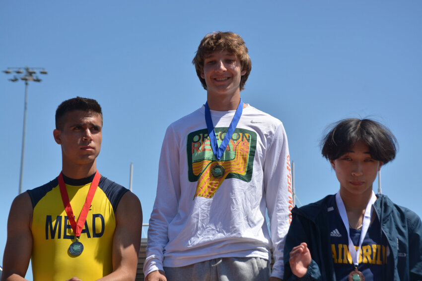 Jordan Lasher smiles atop the podium after a championship victory in the 3A pole vault competition on May 26, 2023.