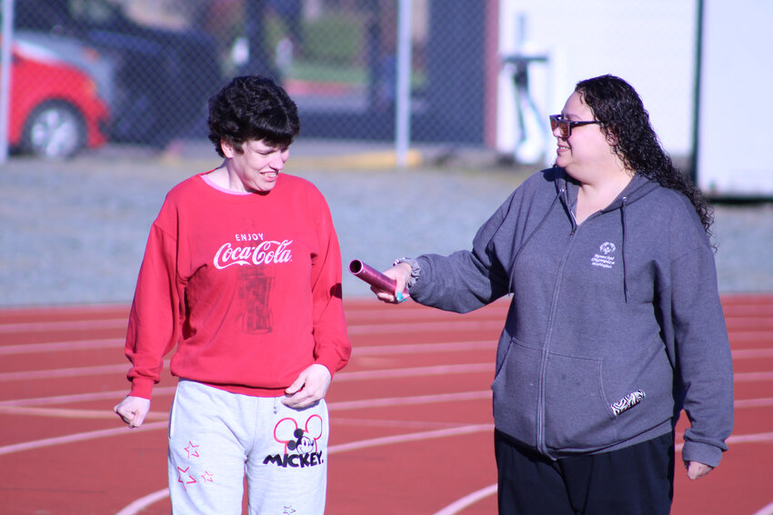 Heidi Cunningham walks with Yelm Wolf Pack assistant coach Brandi Robinson on the Yelm High School track on April 1.