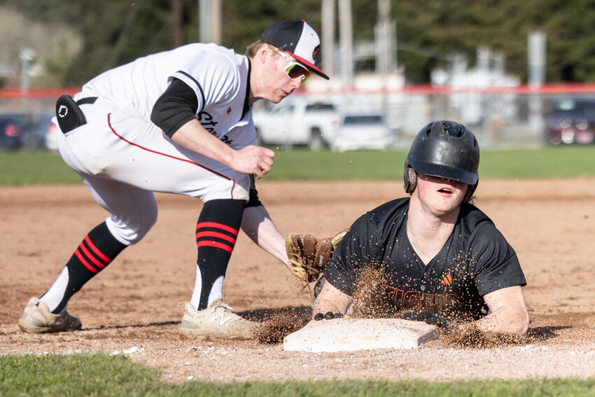 Centralia&rsquo;s Marcus Miller slides into third base during a high school baseball game at Tenino High School on Tuesday, April 9.
