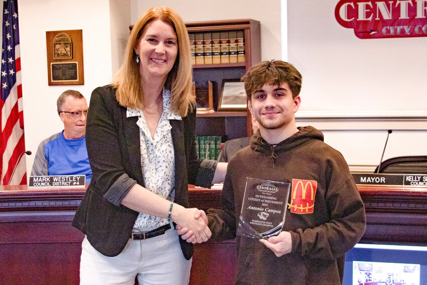 Mayor Kelly Smith Johnston congratulates Centralia High School Wrestler Antonio Campos after presenting him with an Outstanding Citizen Achievement Award during the Tuesday, April 9, Centralia City Council meeting following his wrestling state championship win earlier this year.