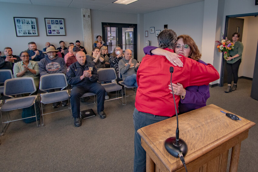 Retiring Chehalis City Manager Jill Anderson hugs Chehalis Mayor Tony Ketchum while being honored during her last city council meeting on Monday, April 8, at Chehalis City Hall.