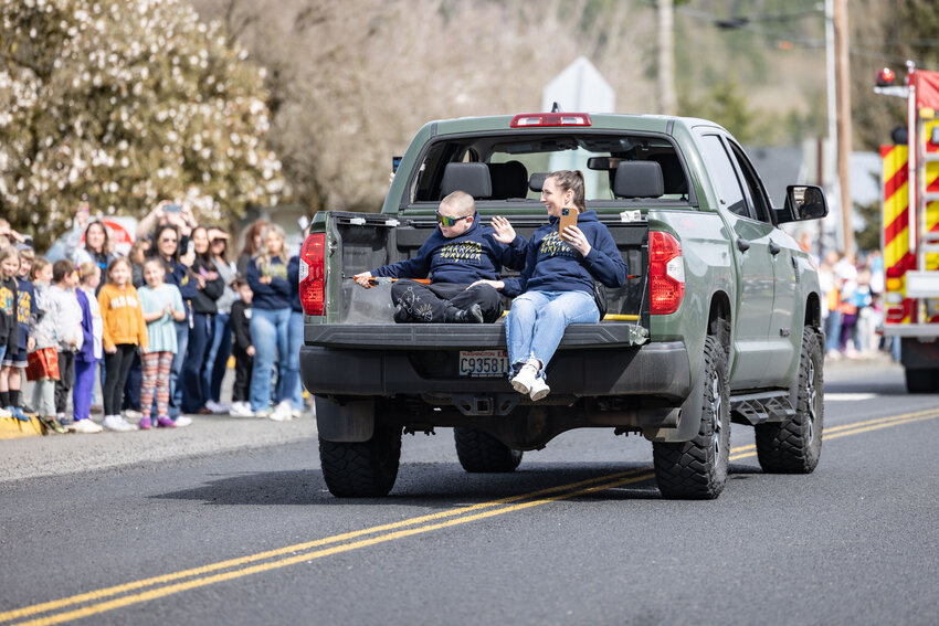 Brody Hamilton and his mom, Grace Hamilton, ride in the back of a truck past Onalaska students and community members at Onalaska Elementary and Middle School on Thursday, April 11. Brody was discharged from Seattle Children&rsquo;s hospital after receiving inpatient care for a brain tumor.