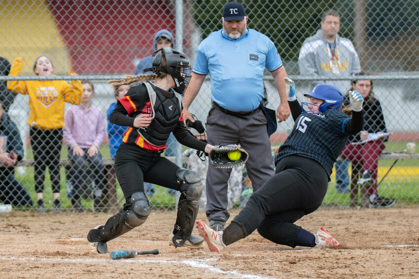 Marisa Del Peso attempts to tag a runner out at home during Winlock&rsquo;s game versus Toutle Lake on Thursday April 11.