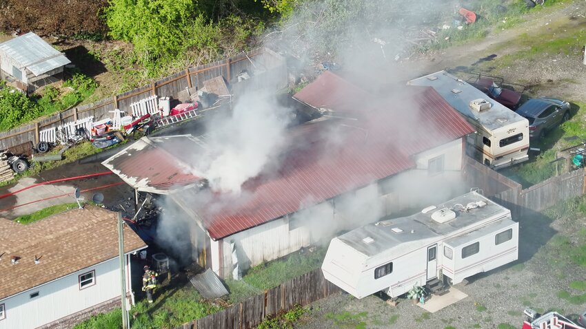 Courtesy photo  A fire in the 1200 block of Centralia Avenue is pictured from above on Friday afternoon in Centralia. Firefighters responded to the blaze, which engulfed a garage, at about 4:30 p.m. No injuries were reported. A relative of the resident of the attached home reported that the quick response by firefighters saved the home, though the resident lost a lot in the fire. This photo was provided by Dale Hylton of Blue Skies Drones.