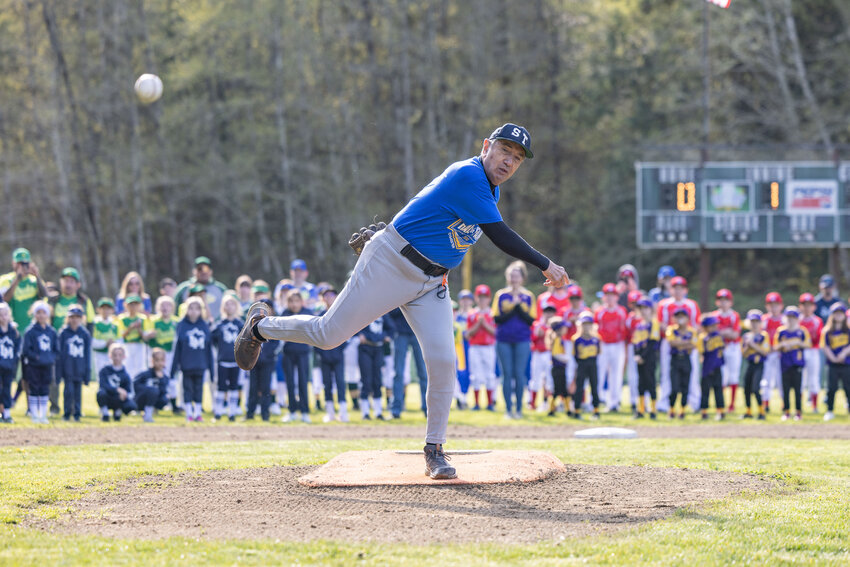 Robin Kristiansen throws the first pitch during the opening ceremony for Larch Mountain Little League at Tenino City Park on Saturday, April 13. Kristiansen and his wife Jennifer were recognized for their many years of service to the community of Tenino.