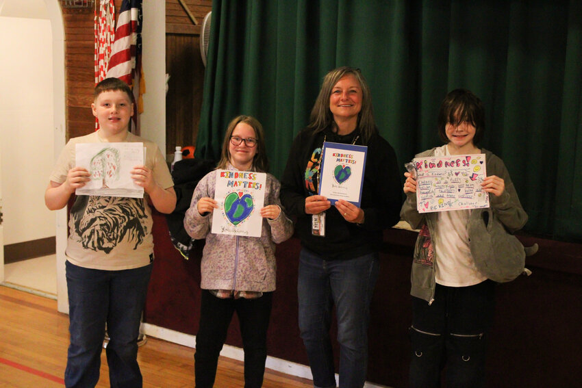 Joey Hatch, Elise Villacian, Shannon Gubser and Julie Denton pose for a photo during a Lackamas Elementary assembly honoring the students' artwork in the 