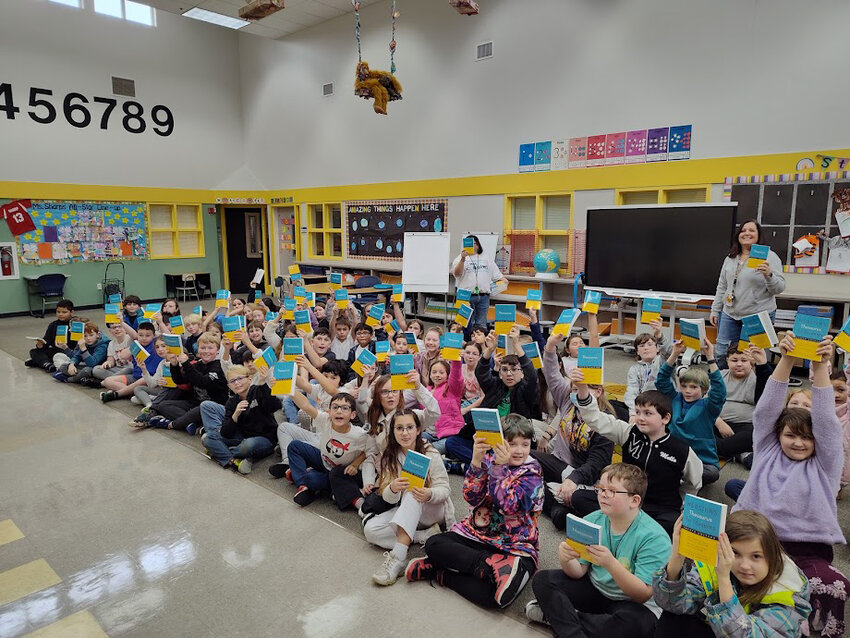 Fourth grade students at Rainier Elementary School receive thesauruses from We Love Rainier WA.
