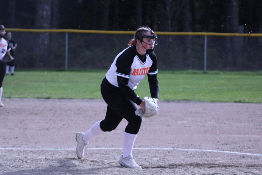 Ryleigh Cruse prepares to throw a pitch against Elma as drops of rain fall around her on April 16.