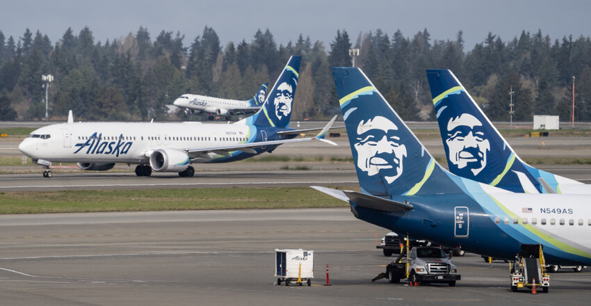 An Alaska Airlines Boeing 737 MAX 9, left, takes off at Seattle-Tacoma International Airport on March 25, 2024 in Seattle, Washington.