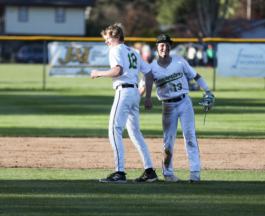 Tumwater's Luke Overbay (18) and Eddie Marson smile after the fifth inning against W.F. West during an Evergreen Conference game on April 17 in Tumwater.