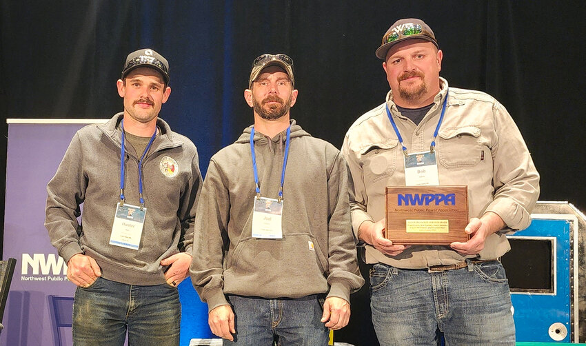 Lewis County PUD&rsquo;s Hunter Blair, Joel Chandler, and Bob Hadley accept the 2024 Safety Heroism Award on behalf of their entire crew.