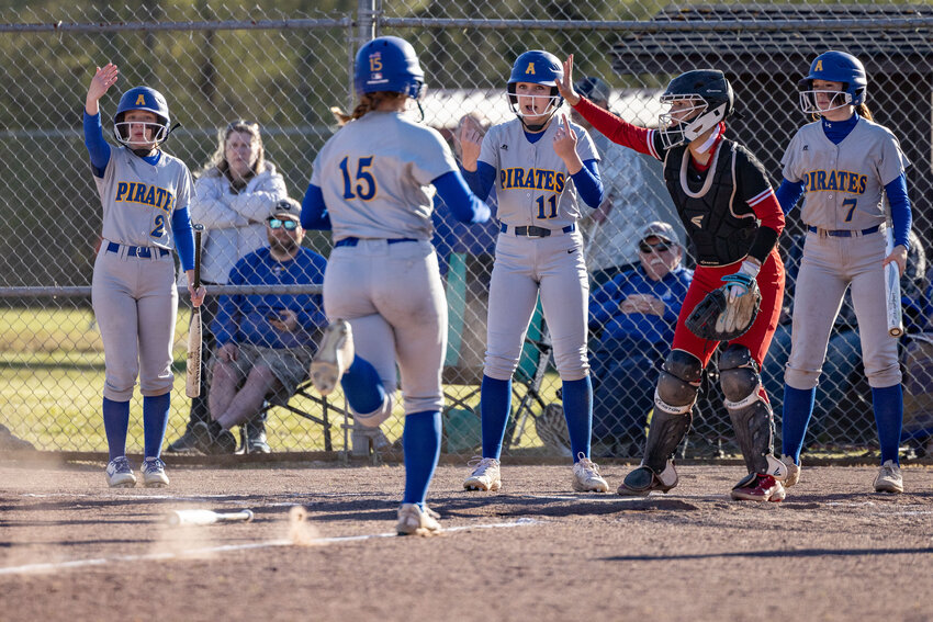 Adna teammates cheer on Adna&rsquo;s Margarite Humphrey to run home during a game at the Toledo softball complex on Thursday, April 18.