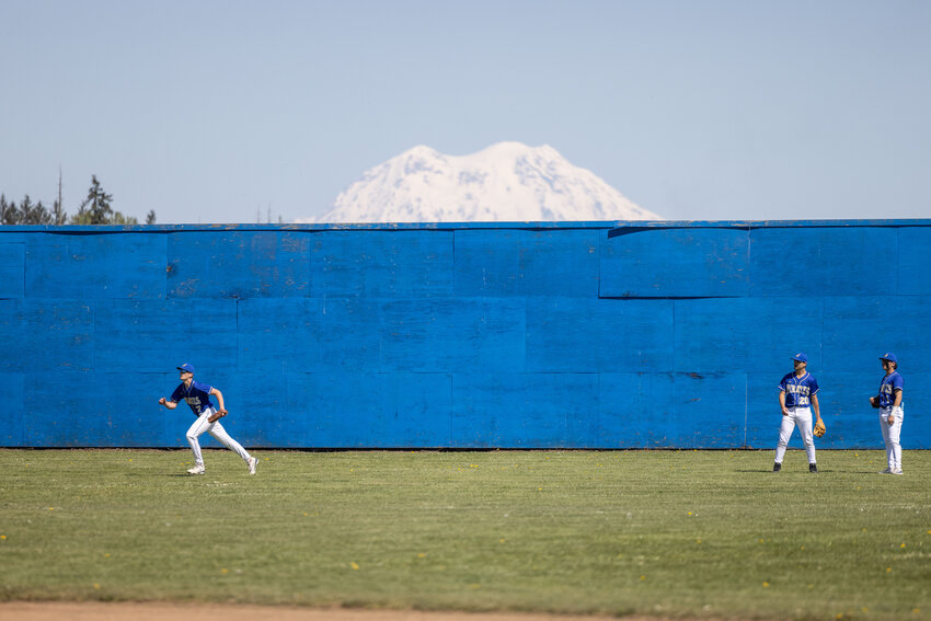 Adna players warm up during a baseball game at Adna High School Friday, April 19.