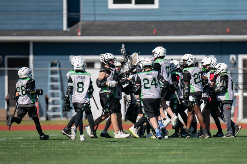 the Twin Cities Lacrosse 5th/6th grade team celebrates after a win over Thurston County at Tiger Stadium in Centralia on Saturday, April 20.