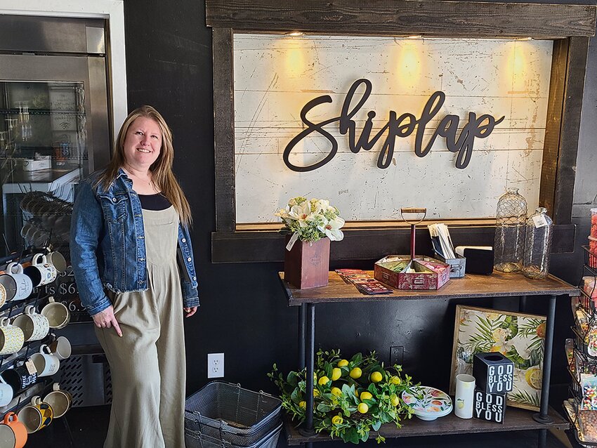 Cyndi Doud, the new owner of The Shiplap Shop & Coffee House in Yelm, poses for a photo at the front of the store on April 19.