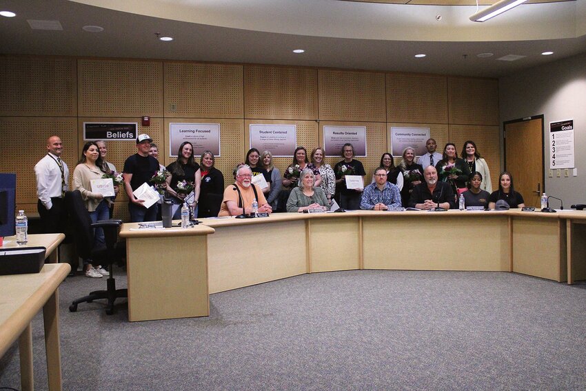 Yelm Community Schools board members pose with the 2023-24 Volunteers of the Year during a board meeting on April 18.