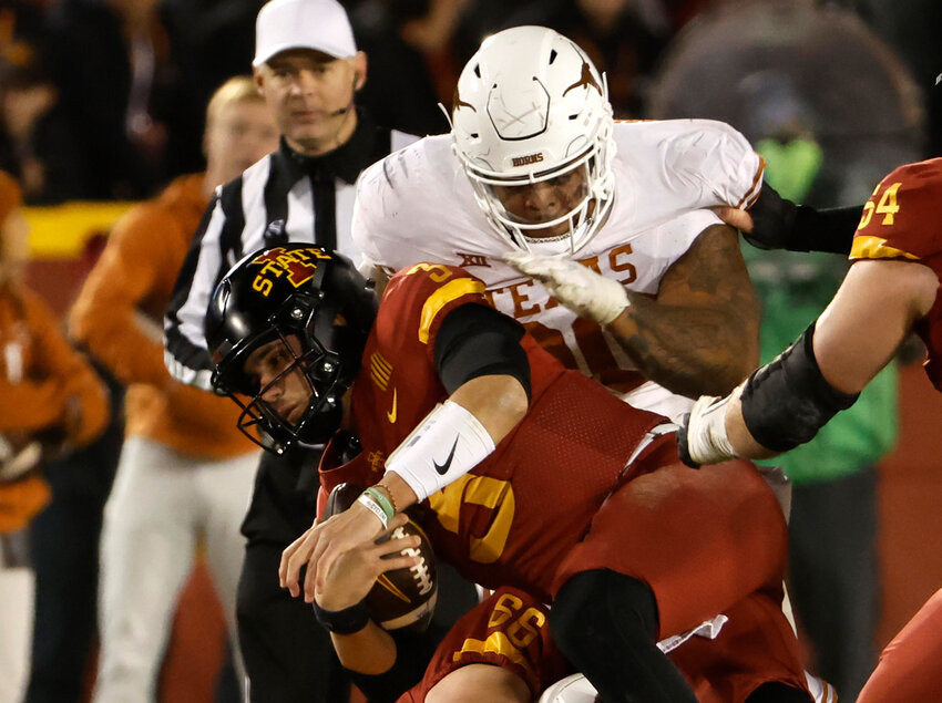 Quarterback Rocco Becht #3 of the Iowa State Cyclones is tackled by defensive lineman Byron Murphy II #90 of the Texas Longhorns in the second half of play at Jack Trice Stadium on November 18, 2023 in Ames, Iowa. The Texas Longhorns won 26-16 over the Iowa State Cyclones. (Photo by David Purdy/Getty Images/TNS)