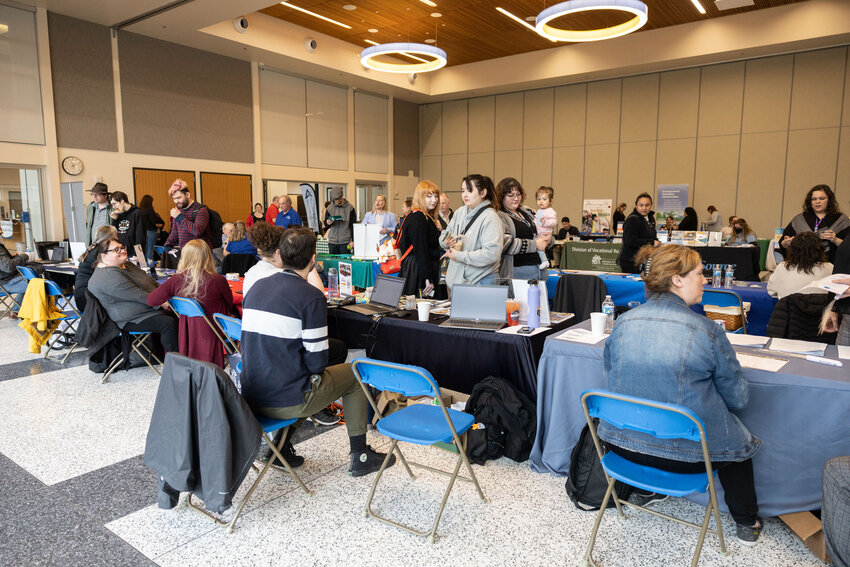 Students, teachers and community members walk around to different career tables during the Inclusive Career Fair on Thursday, April 25.