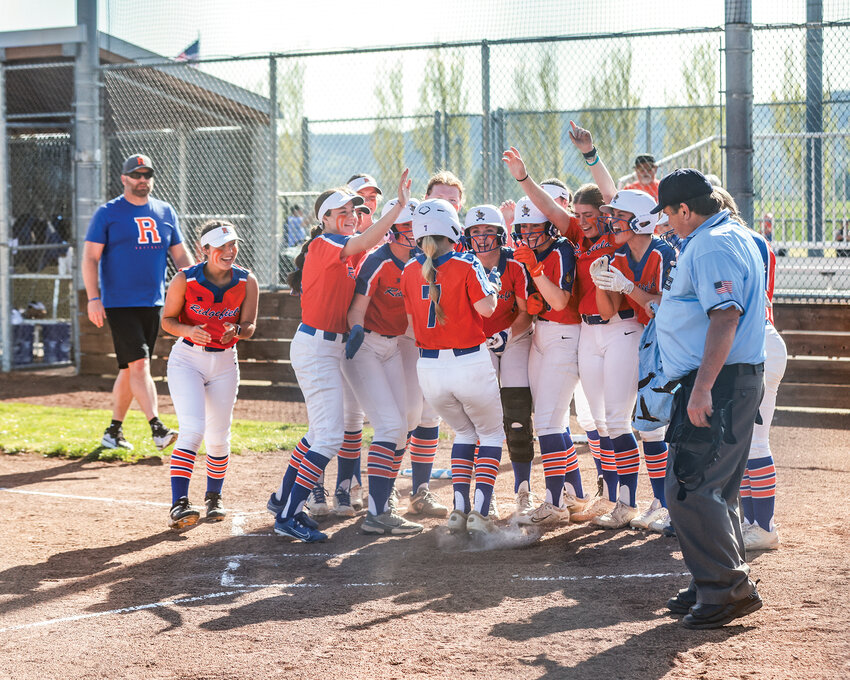 Ridgefield&rsquo;s Charlie Harris steps on home plate while her team celebrates her second-inning home run during the Spudders&rsquo; 16-0 win over the Woodland Beavers, Tuesday, April 23.