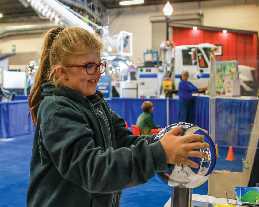 Sonja Lee&rsquo;s hair stands up while holding onto the Van de Graaff generator at the Home and Garden Idea Fair at the Clark County Event Center on Saturday, April 27.