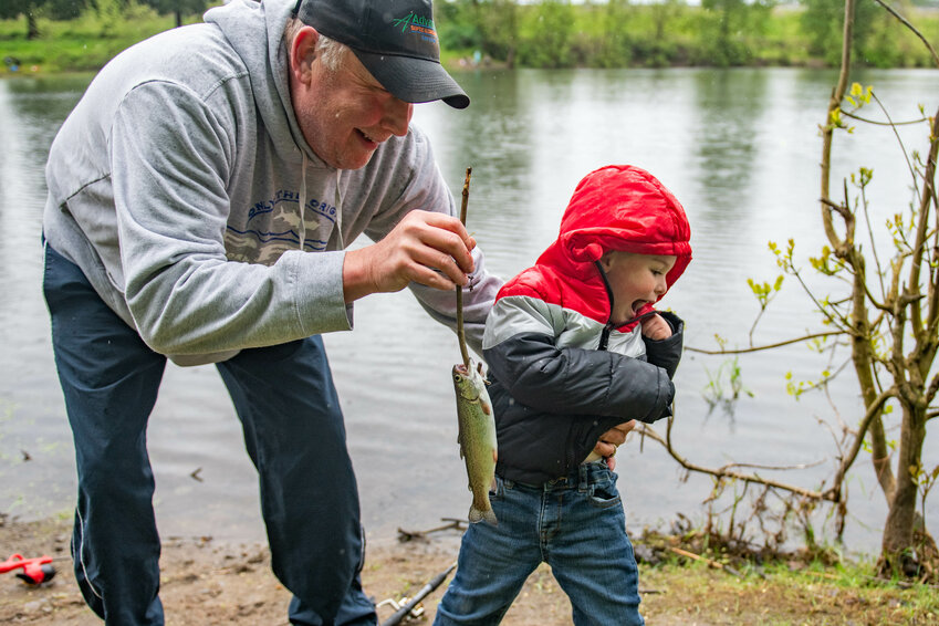 Andrew Johnson attempts to run away while his grandfather Robbert Gordon holds up his first catch of the day at the Centralia Lions Club Youth Fishing Derby at Fort Borst Park in Centralia on Saturday, April 27.