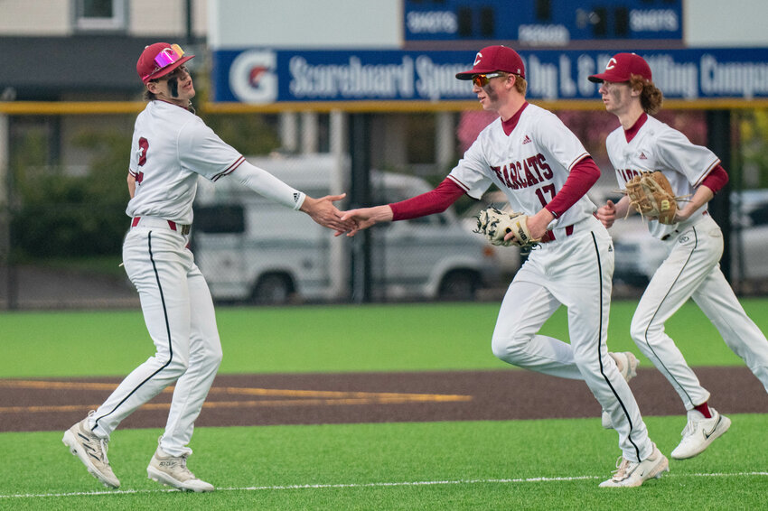 Braden Jones and Jake Redmund high five as they leave the field during W.F. West&rsquo;s win over Centralia at Centralia College on Monday, April 29.