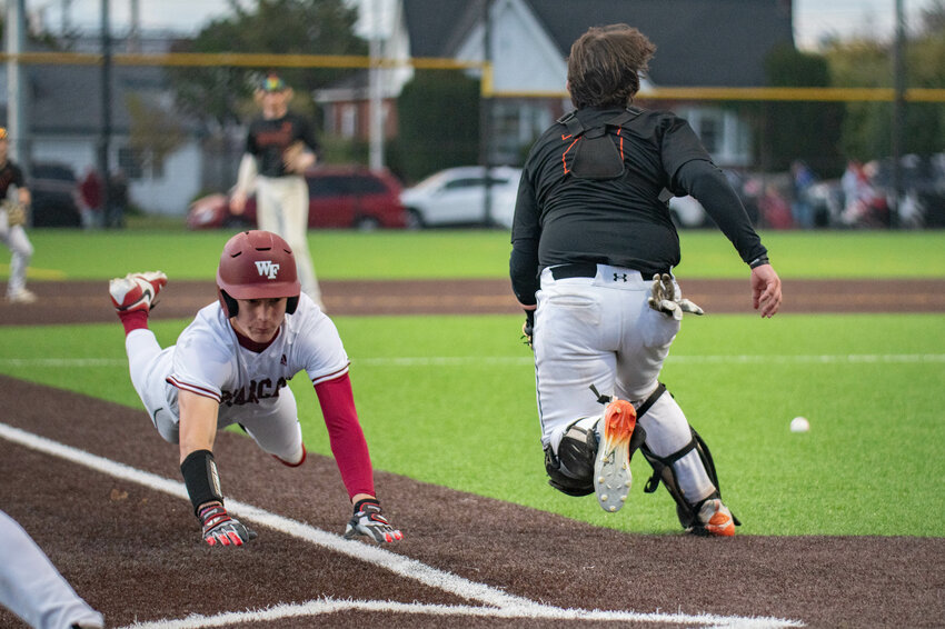 Connor Coleman dives for home plate during W.F. West&rsquo;s win over Centralia at Centralia College on Monday, April 29.