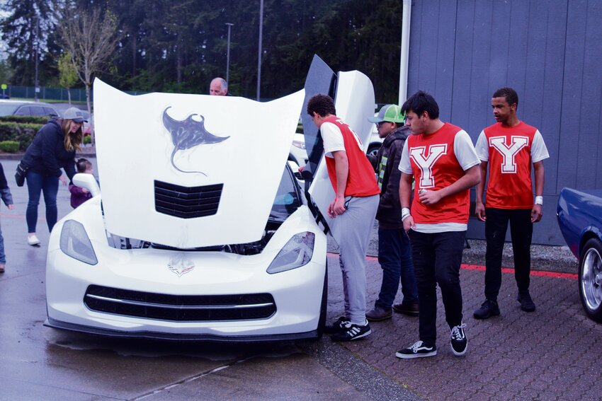 Members of the Yelm High School Team Unified soccer team check out a Chevrolet Corvette on display at the Nisqually Valley Spring Expo Car Show on April 27.
