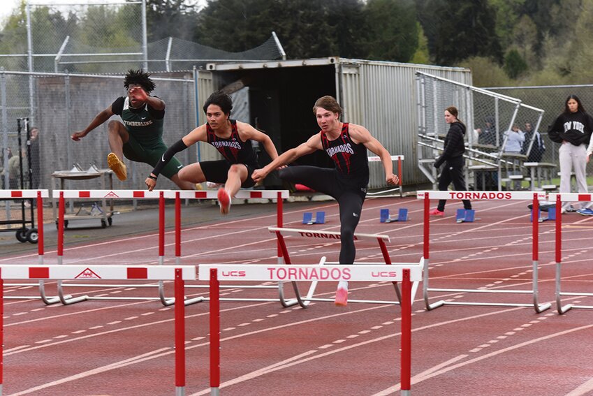 Yelm's Latrel Fabian (left) and Jordan Lasher (right) leap over hurdles during the 110-meter hurdle competition on Thursday, April 25, in Yelm.