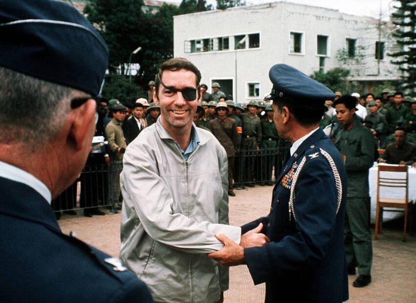 Yelm veteran Lewis Shattuck sports an eyepatch and shakes hands with fellow U.S. Air Force service members at the Gai Lam Airport after being released from a North Vietnamese prisoner of war camp, where he was held captive for more than six years, in 1973.