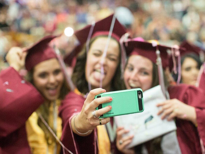 Three W.F. West High School graduates take a break for a selfie after receiving their diplomas in this 2016 Chronicle file photo.