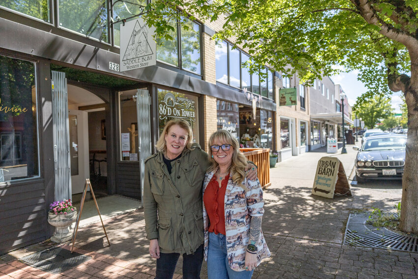 Owners Laura Duthie, left, and Jeannie Gluck pose for a photo outside the new 86&rsquo;d on Tower located between their stores, Saddle Bum and Urban Farmgirl Market, in Centralia on Thursday, May 2.