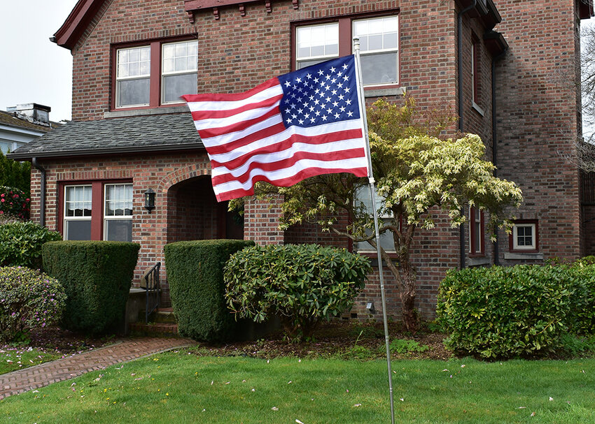 An American flag is planted in a front yard in this photo provided by the Centralia Rotary Club.