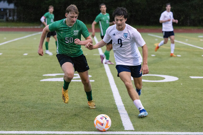 Tumwater&rsquo;s Nathan Boone and Hockinson&rsquo;s Trevor Holmes run to the ball during a Class 2A District 4 quarterfinal soccer game at Tumwater High School on Saturday, May 4.